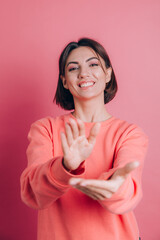 Woman wearing casual sweater on background clapping and applauding happy and joyful, smiling proud...