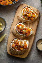 Baked pumpkin, tahini and cream cheese bruschettas, top view