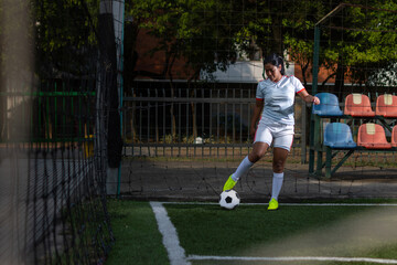 Latin female soccer player ready to kick a corner. Female football player concept