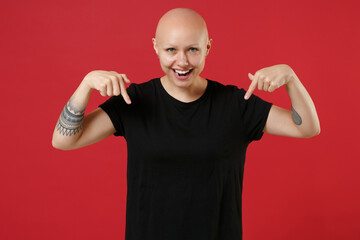 Young bald caucasian tattooed smiling happy woman 20s without hair in black basic casual t-shirt...