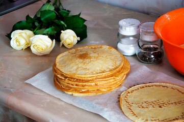 still life pancakes on the kitchen table, white roses, spices. High quality photo