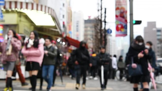 Blurred motion : pedestrians walking at Akihabara district Tokyo Japan