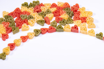 Italian ttree color heart shaped pasta on white background with copy space