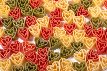 Italian ttree color heart shaped pasta background.