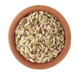 Mix seeds, sunflower, sesame, linseed and pumpkin seed in clay pot isolated on white background, top view