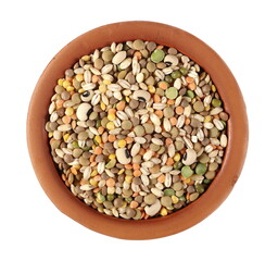 Mixed legumes and cereals, peeled barley, green, yellow and dark red lentils, half green peas, black white beans, green beans in clay pot isolated on white background, top view