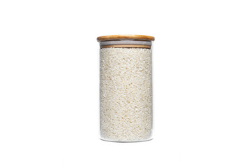 Rice in a glass jar isolated on a white background.