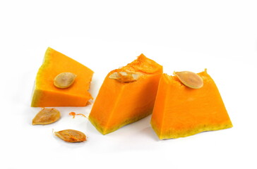 Pieces of pumpkin isolated on white background. Pumpkin seed. Pumpkin pieces cut in a cube slice isolated on white background. 