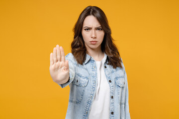 Young strict serious indignant sad caucasian brunette woman 20s in casual stylish denim shirt white...