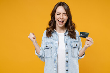 Young overjoyed happy brunette rich successful woman in denim shirt white t-shirt hold in hand...
