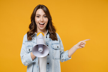 Young expressive fun woman 20s wear denim shirt white t-shirt screaming hot news shouting aside in...