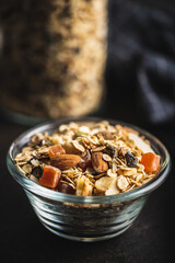 Beakfast cereals in bowl. Healthy muesli with oat flakes, nuts and raisins