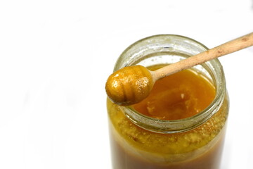 Crystallized honey flow from a dipper, close up.