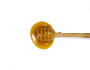 Crystallized honey flow from a dipper, close up.