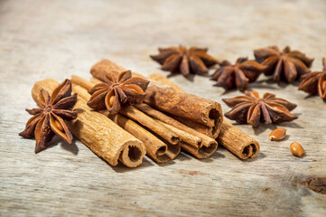 Cinnamon sticks and star anise close-up on a wooden background. Selective focus.