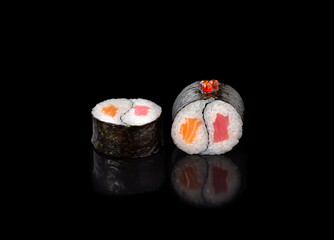 sushi rolls on a black background, japanese cuisine