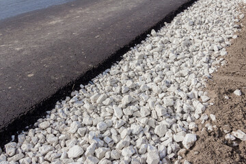 New motor road. Paved bituminous asphalt based on gravel. Road layers. Road composition
