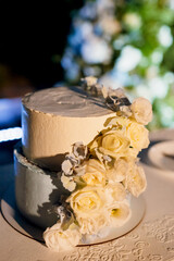 wedding cake on a wooden bench against a waterfall background