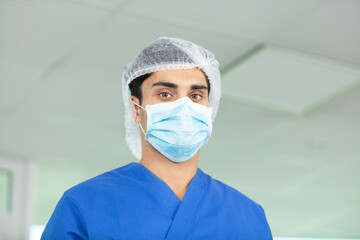 Fototapeta na wymiar doctor in blue uniform standing in hospital