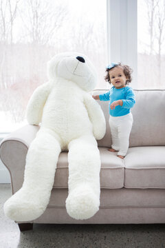 Little Girl With A Giant Teddy Bear