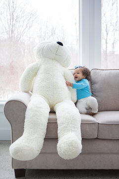 Little Girl With A Giant Teddy Bear