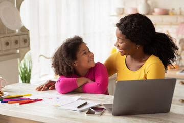 Upbringing Concept. Portrait Of Happy African American Mom And Daughter In Kitchen