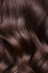 A closeup view of a bunch of shiny curls brown hair © Kobrinphoto