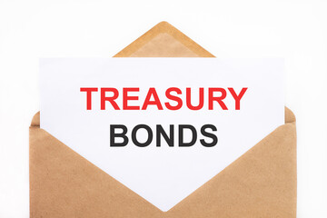 A white sheet with the text treasury bonds lies in an open craft envelope on a white background with copy space. Business concept image