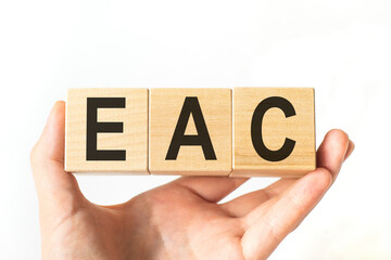 Hand holds wooden cubes with letters eac. Business concept image.