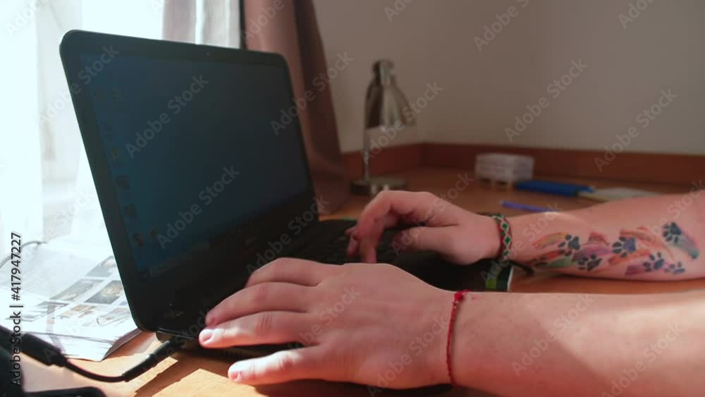 Poster the guy's hands are typing text on the laptop keyboard. preparation of a text document. home educati