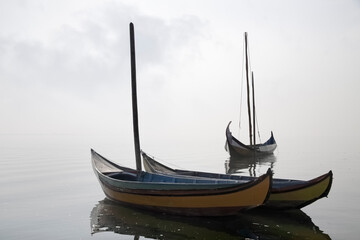 Fototapeta na wymiar Traditional fisherman wooden boats in the fog