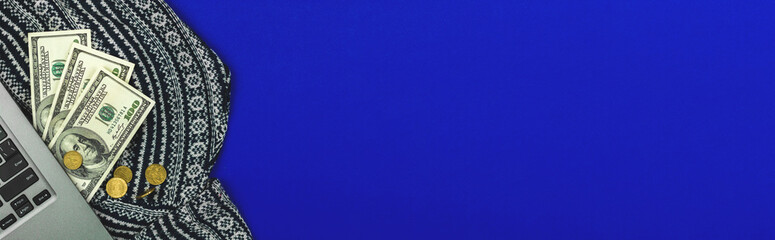 Fototapeta premium Office desktop with laptop and money, banner with blue background,copy space