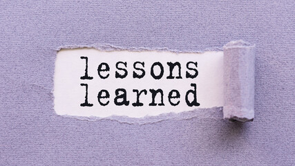 The text LESSONS LEARNED appears on torn lilac paper against a white background.