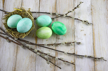 image of festive easter eggs and willow branches on a wooden table