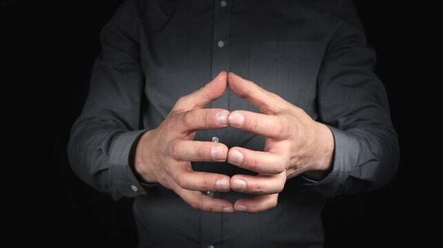 male hands gesture concentration and constructiveness, hands form a roof with a gesture