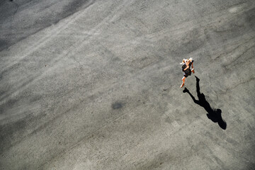 Woman running on road during sunny day