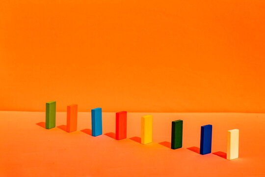 Colorful rectangular block arranged in a line on orange background
