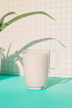 Milk Cup On Blue Table Against Checked Pattern Wall