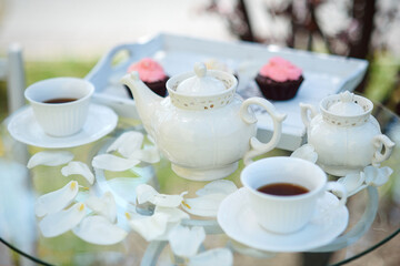 Fototapeta premium Tea drinking black tea with porcelain cups and a teapot