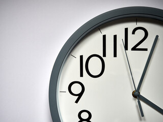 white round analog clock on white background