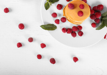 Tasty american pancakes with raspberries and mint. Top view with copy space