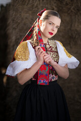 Young beautiful slovak woman in traditional dress. Slovak folklore