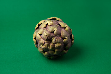 Fototapeta premium Fresh Artichoke on the dark green background