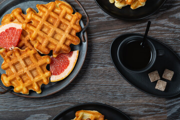 Waffle breakfast with grapefruit and coffee.