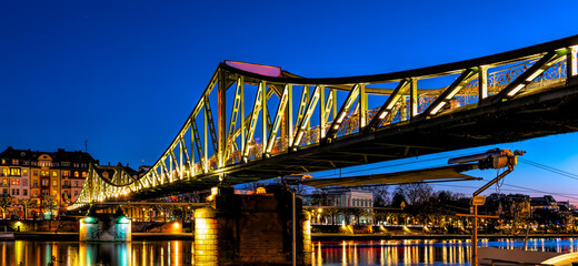 Panorama of the Eiserner Steg bridge at blue hour in Frankfurt am Main, Germany