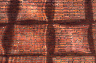 old red brick wall with modern building windows reflections - city background in sunny day