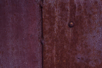 old rusted metal background with cracked paint and nail, old door surface
