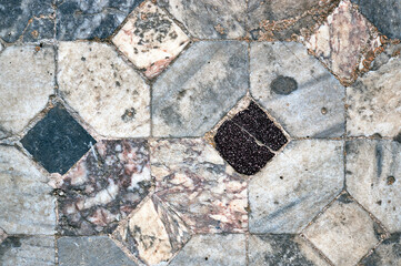 Fragment of mosaic on the floor of the ruins of an ancient building