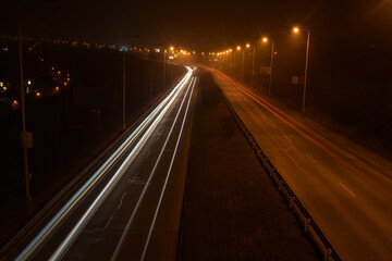 Fototapeta na wymiar Night blurred traffic, light lines, highway 