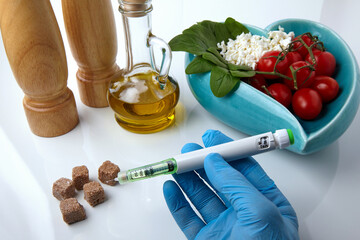 Hands in medical gloves hold a syringe pen with insulin
